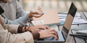 Group of people in discussion at a wooden table